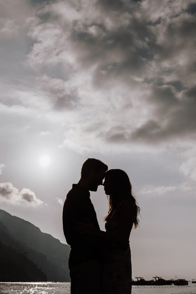 silhouette couple at sunset on Amalfi Coast with sea and mountains