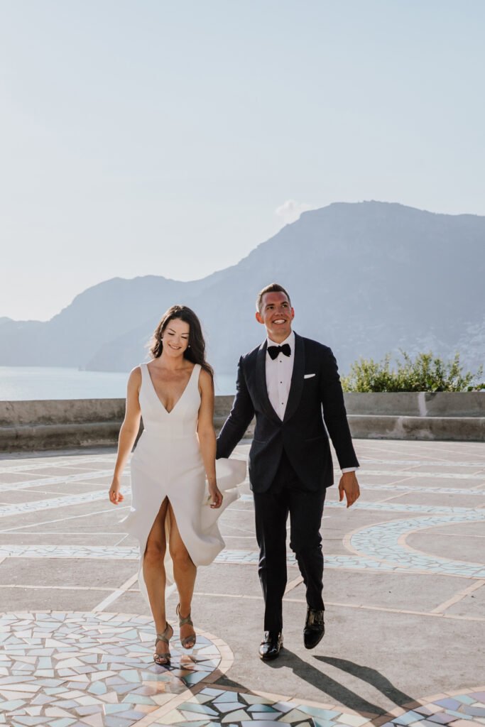 elegant wedding couple walking with sea view on Amalfi Coast Italy