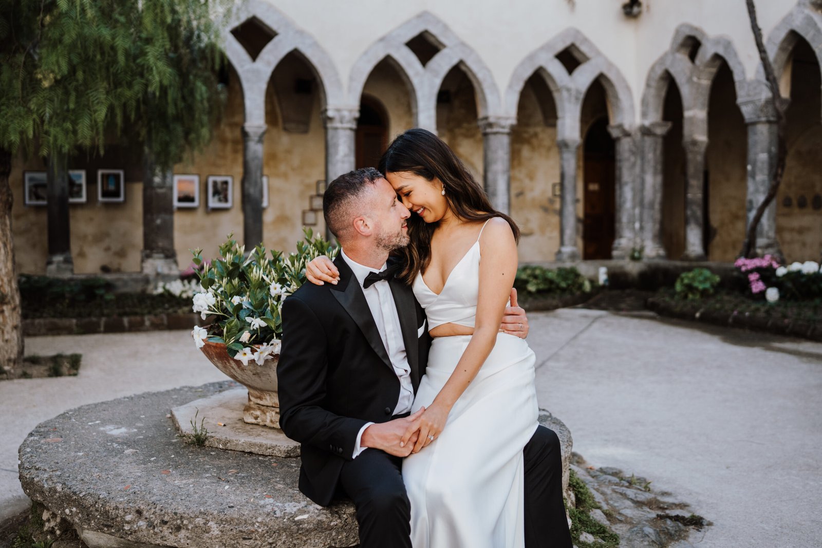 Elegant wedding couple embracing in a historic courtyard in Sorrento on the Amalfi Coast