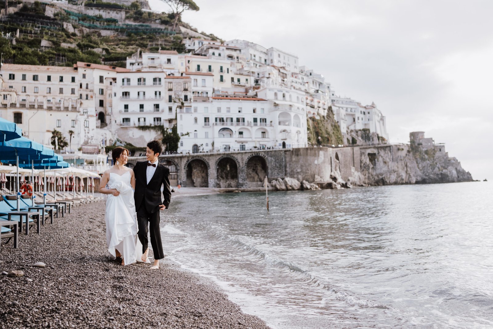 honeymoon photoshoot in amalfi couple wearing wedding dress