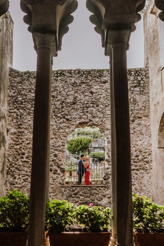 romantic couple in Ravello historic villa with stone architecture and arches